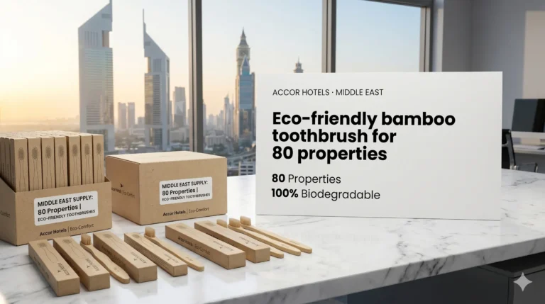 Successful Projects 5 A tabletop product display on a marble desk overlooking a Middle East city skyline, featuring kraft paper boxes and loose bamboo toothbrushes branded for Accor Hotels next to a large white info card detailing eco-friendly supply for 80 properties.